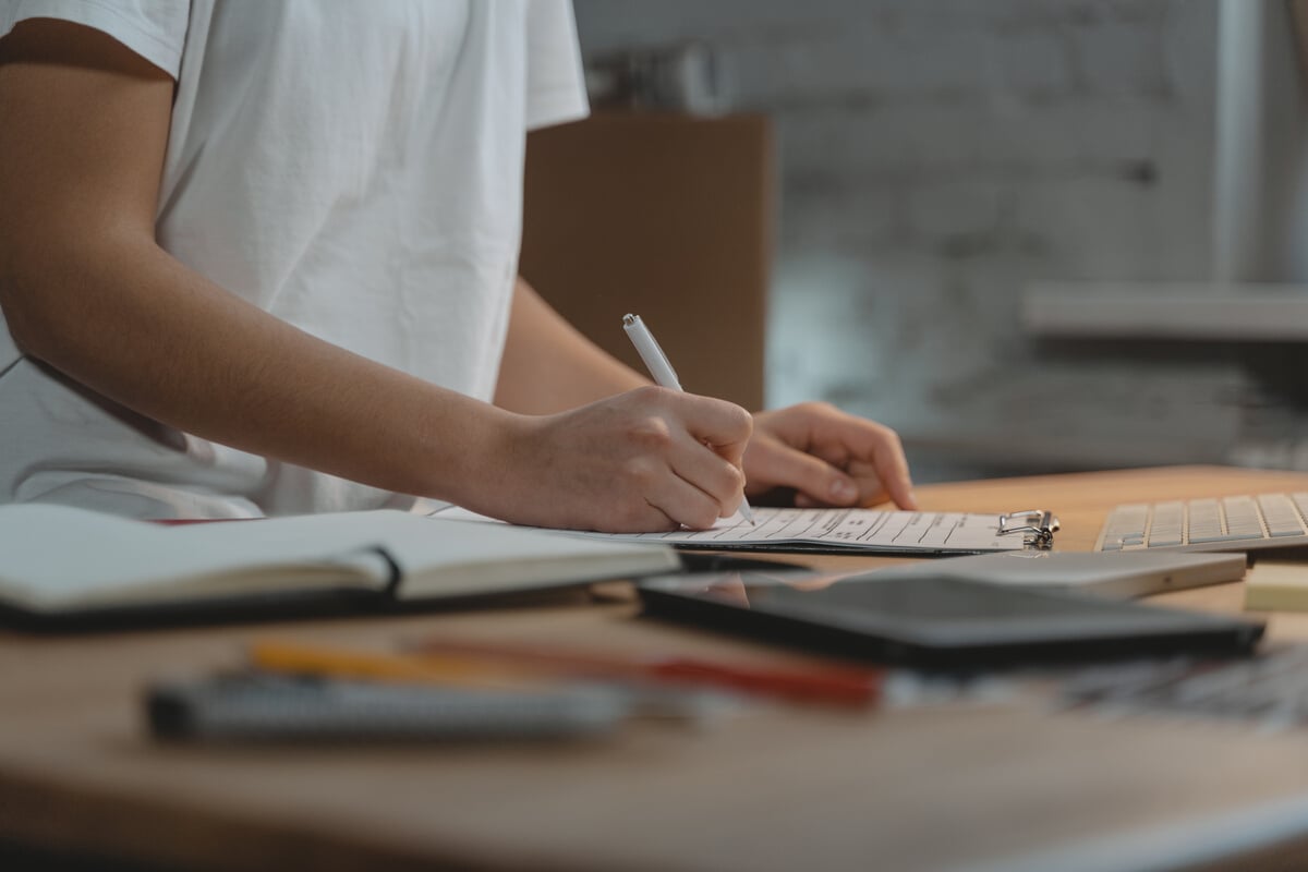 Close-up Photo of Person writing on a Paper